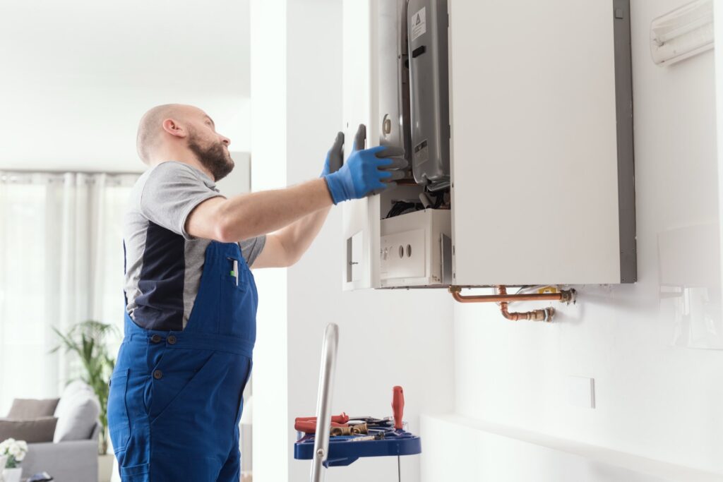 A man installing a broiler