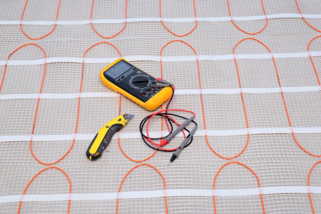 Installation tools on heating cable for warm floor close-up.